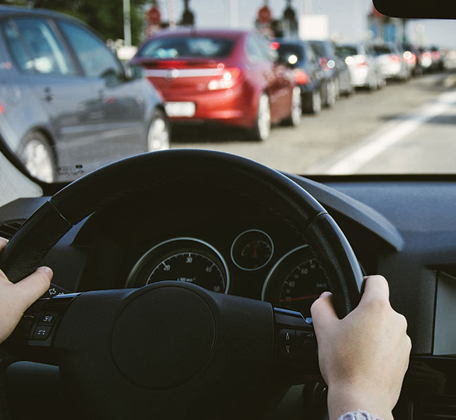 Hands on Steering Wheel Inside of a Car R & Y A/C Compressors®
