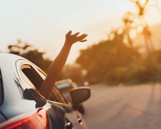Hatchback Car travel driving road trip of woman summer vacation in blue car at sunset
